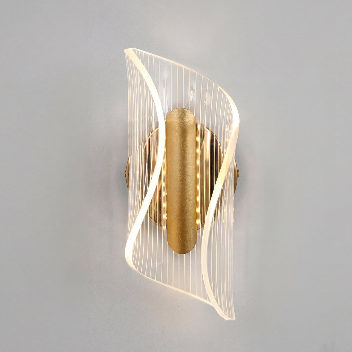 Vista frontal del aplique LED Vortex Gold en una pared gris minimalista con iluminacion suave.