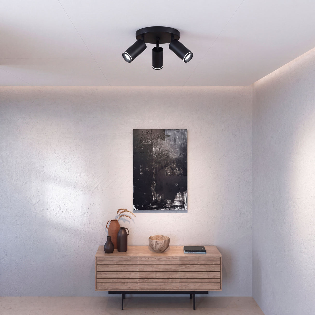 Puntos de luz focal dirigidos hacia la zona social dentro de estancia con acabados premium.