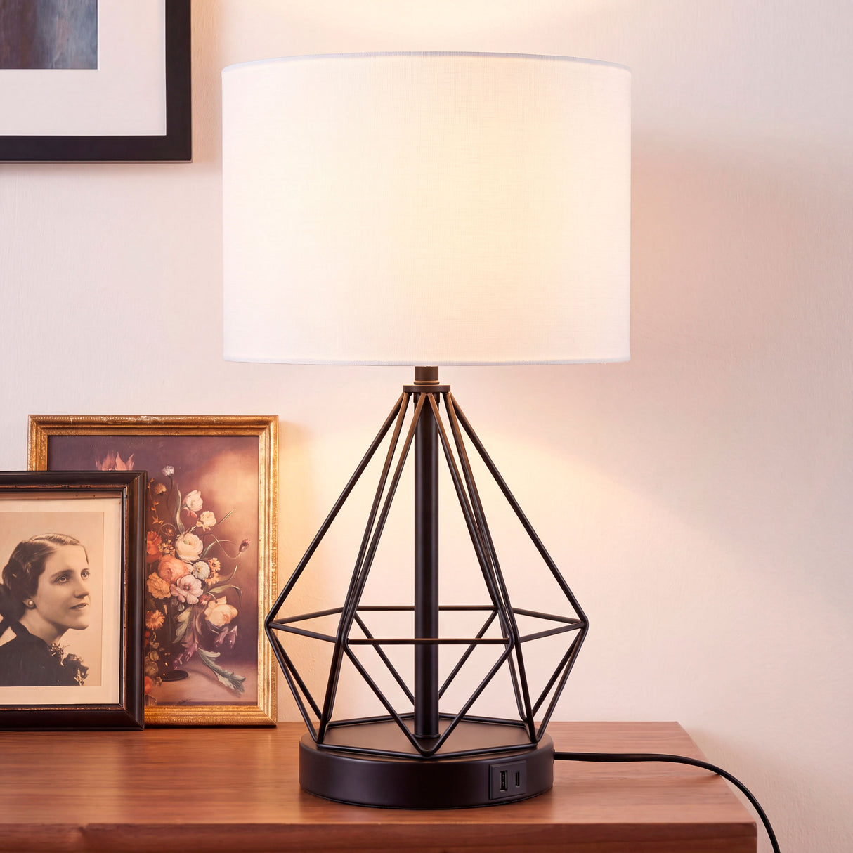 Luz de acento sutil sobre mueble recibidor que destaca texturas en muros y elementos artísticos.