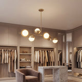 Tienda de ropa exclusiva iluminada con lamparas lineales doradas modelo Nova.