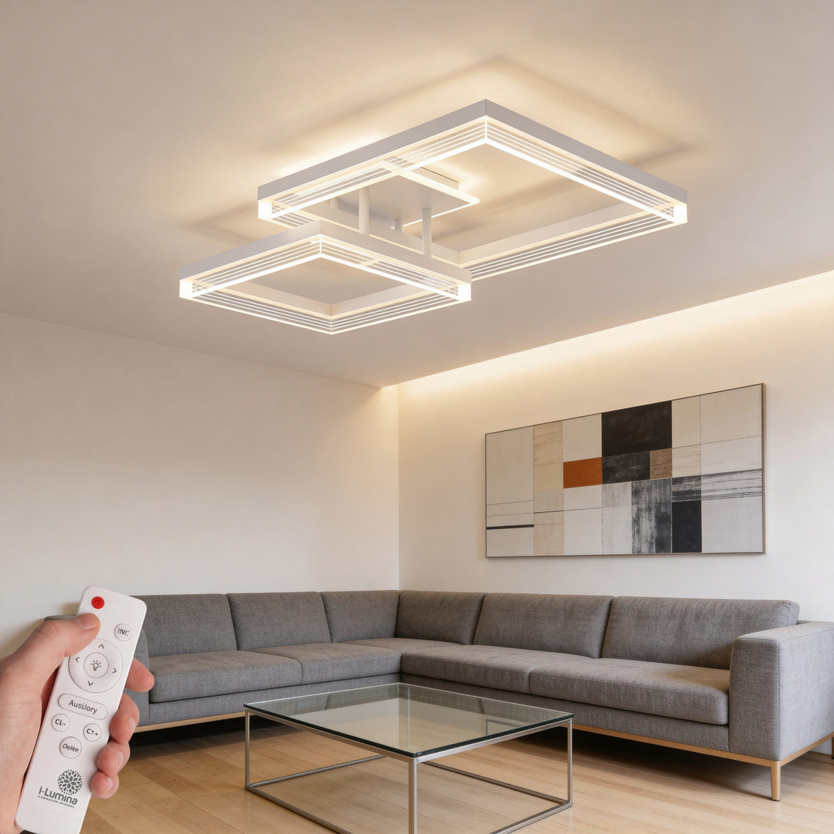Lámpara de techo blanca sobre mobiliario gris oscuro, creando un punto de luz escultórico funcional.