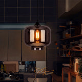 Punto de luz cenital colgante instalado en una cocina de concepto abierto con repisas de madera.