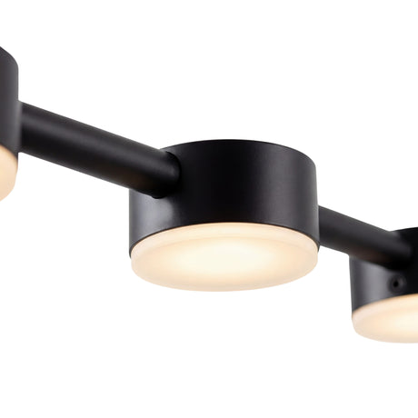 Primer plano de foco led cilindrico negro con difusor blanco opaco iluminado.