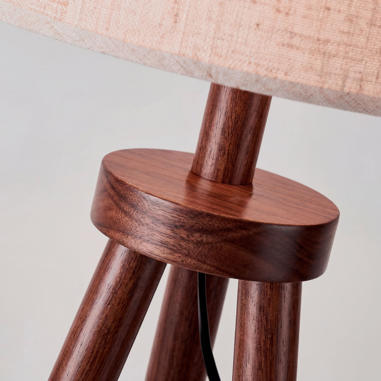 Close-up de pieza circular de unión metálica y vetas de madera tratada con acabados premium.