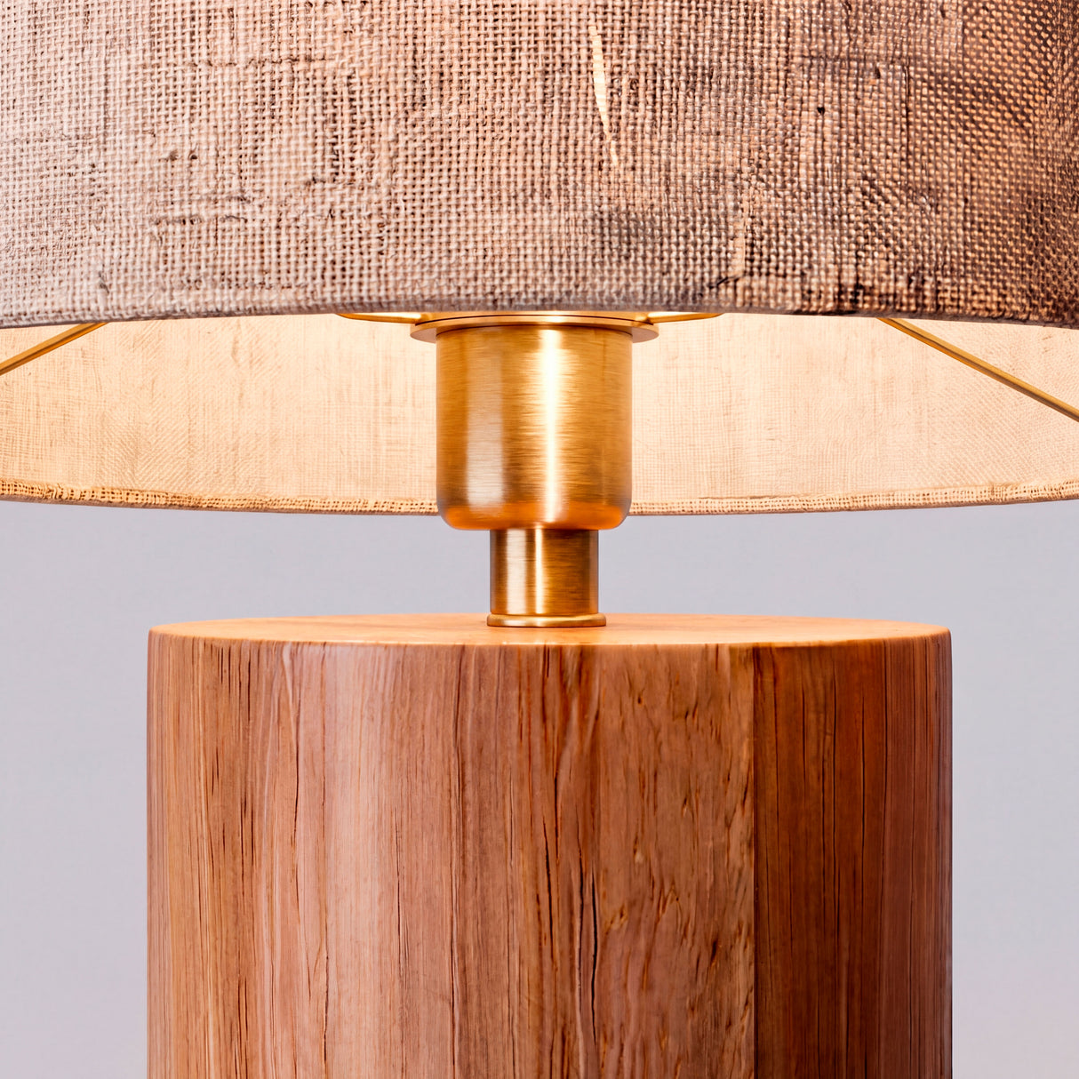 Primer plano de la textura de la madera clara y el cabezal de latón cepillado.