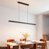 Punto de luz minimalista sobre mesa de comedor redonda en estancia de diseño limpio.