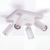 Estructura cuadrada metálica de sobreponer con cuatro spots direccionables de estilo limpio.