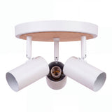 Estructura circular metálica de sobreponer con tres spots direccionables de estilo nórdico limpio.
