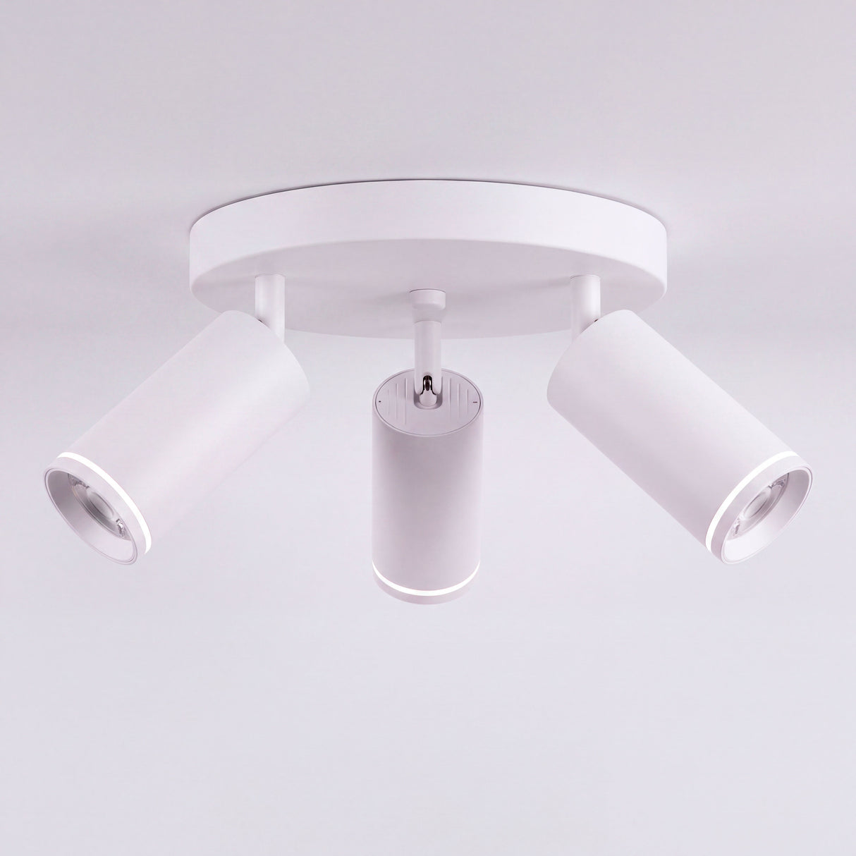 Estructura circular metálica de sobreponer con tres spots direccionables de estilo limpio.