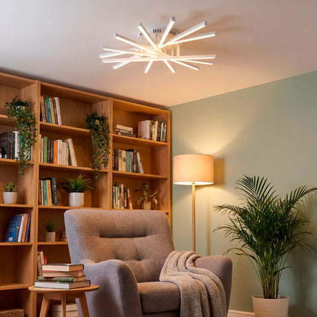 Lámpara Mirabella White sobre zona de relax proporcionando una luz envolvente.