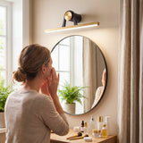 Uso funcional de luminaria integrada sobre un espejo circular de baño maximizando la eficiencia lumínica.