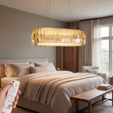 Lámpara de suspensión sobre cama de dormitorio creando una atmósfera de descanso relajante.