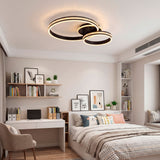Plafón circular negro en dormitorio con escritorio y estanterías de libros.