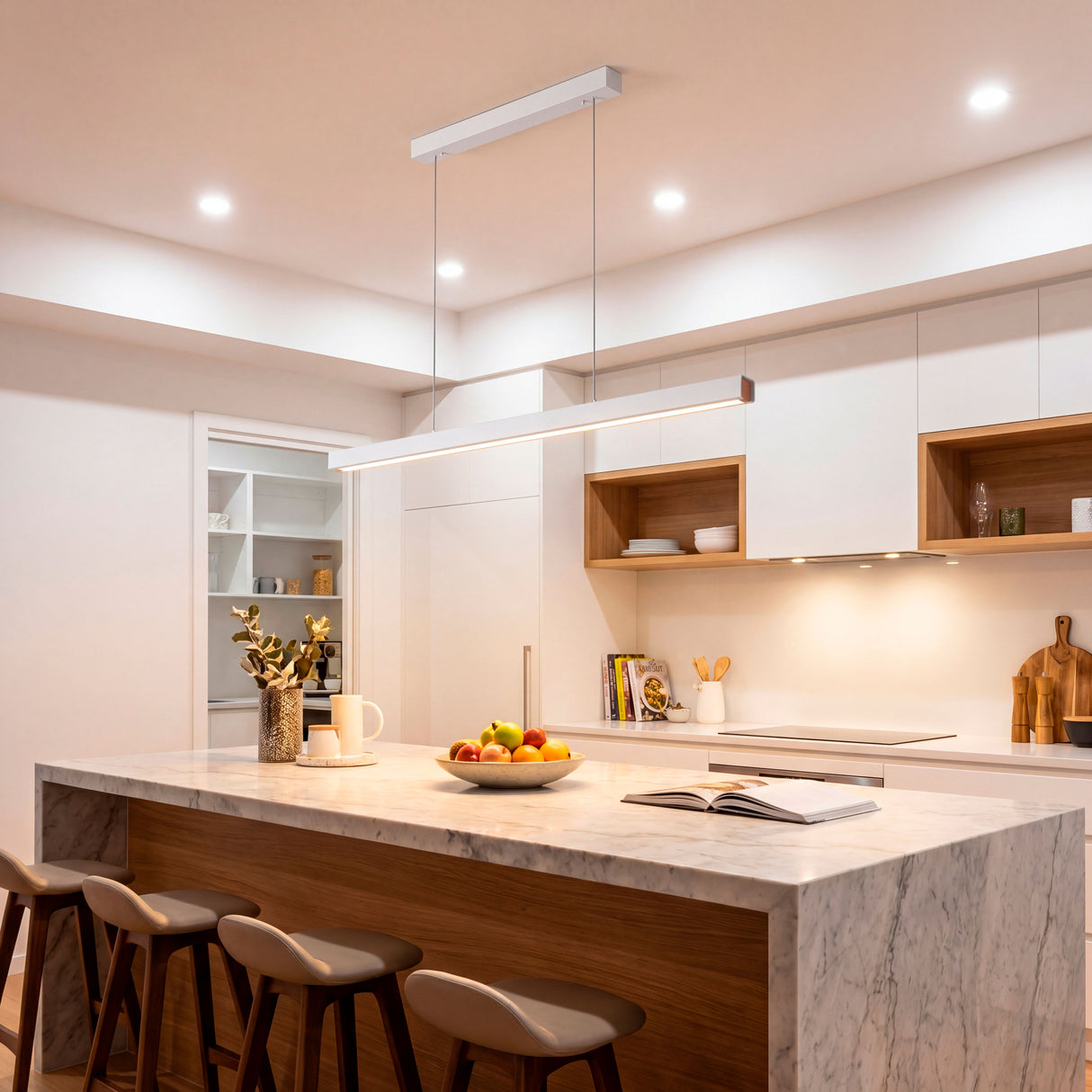 Perfil lineal blanco suspendido sobre encimera de cocina moderna con muebles blancos.