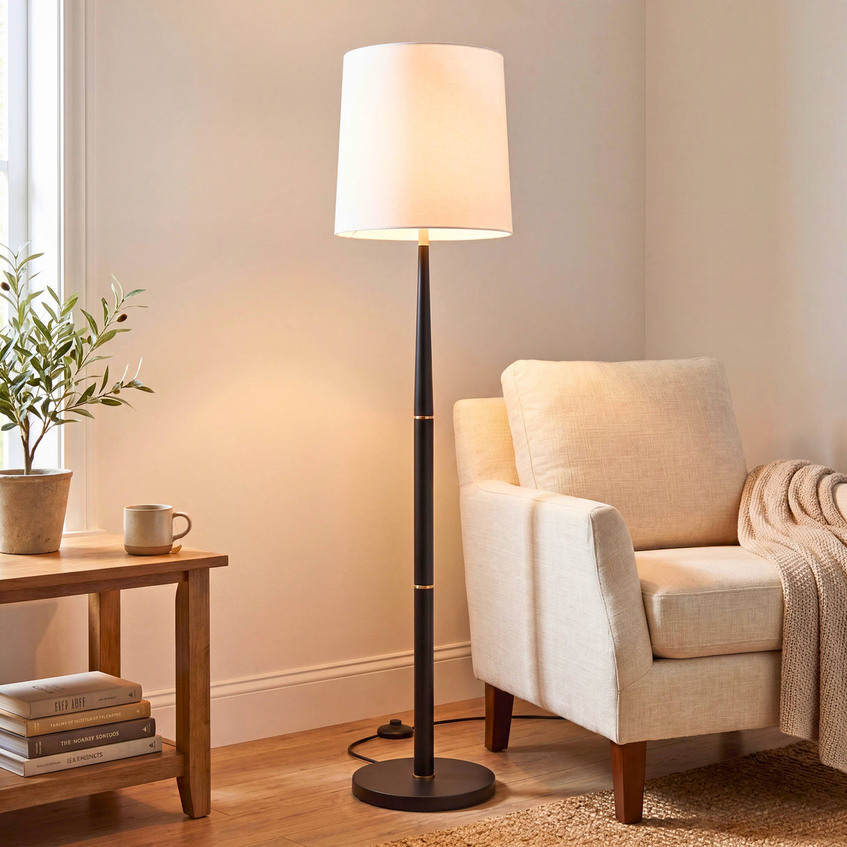 Configuración de rincón acogedor combinando madera natural, textiles claros y una fuente de luz suave y cálida.