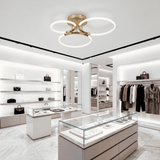Aplicación en tienda de moda de alta gama con estanterías blancas y luz neutra brillante.