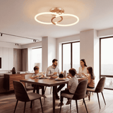 Escena de comedor con lámpara de diseño en tono oro y luz envolvente para reuniones.