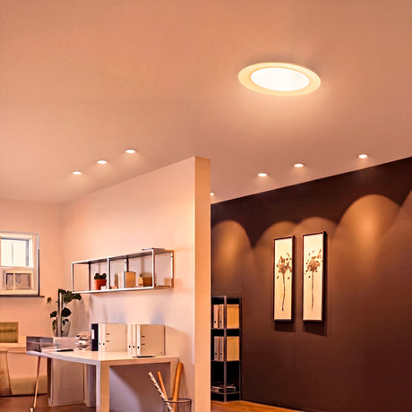 Spot circular LED de 18W integrado en techo de oficina moderna con luz de 3000K.