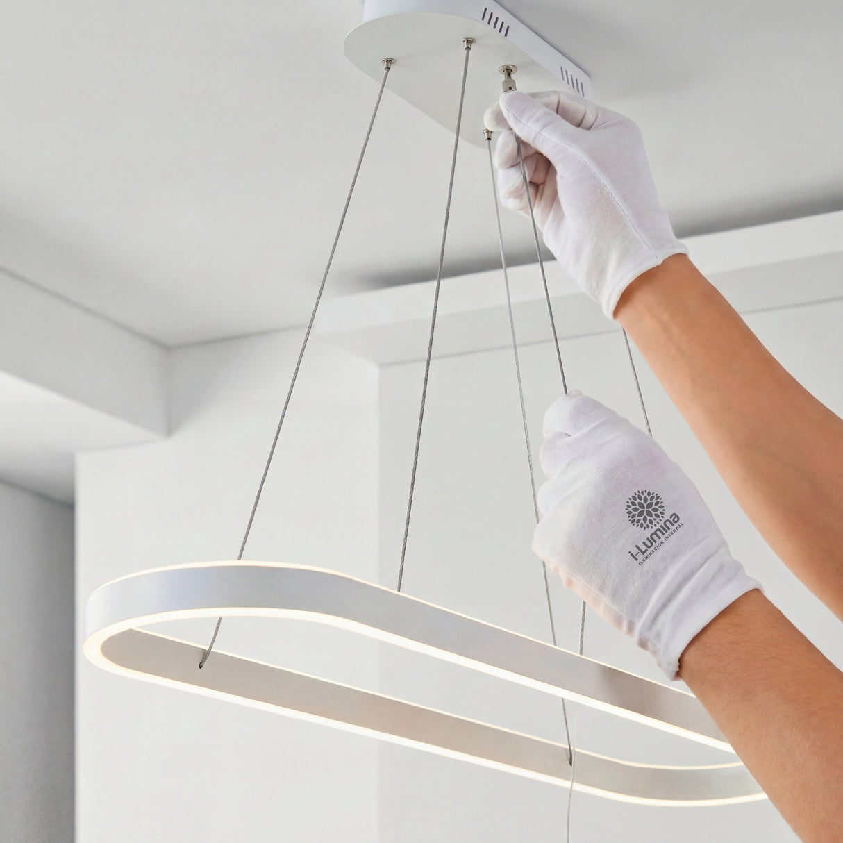 Proceso de ajuste de altura para lámpara colgante lineal con cables de acero.