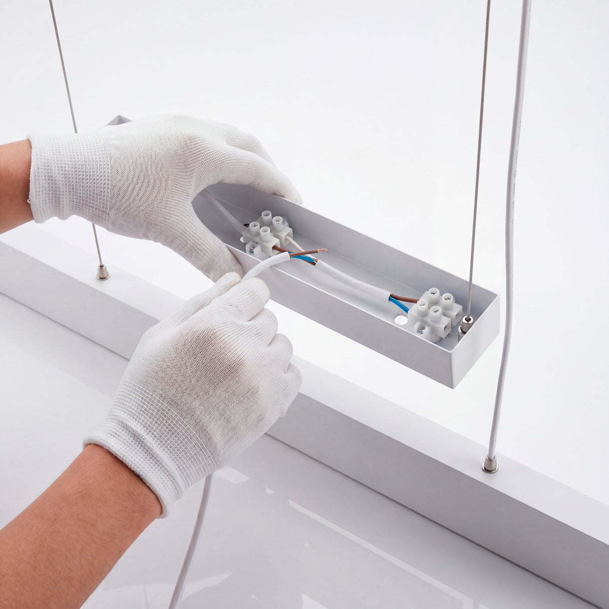Detalle del cableado interno y montaje profesional con guantes de protección técnica.