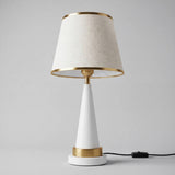 Lámpara de mesa AURELIA WHITE AND GOLD blanca y dorada sobre fondo gris neutro