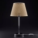 Lámpara de mesa CAPRI encendida con luz cálida sobre fondo negro