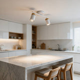Lámpara de spots dirigibles iluminando cocina blanca moderna