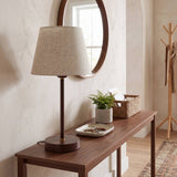 Lámpara decorativa NORA WALNUT en consola de madera con espejo redondo