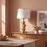 Lámpara decorativa PIETRA GOLD sobre consola en recibidor elegante