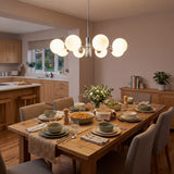 Lampara de techo cosmos silver estilo sputnik en comedor moderno con luz calida