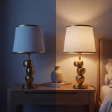 Lámpara de velador PIETRA GOLD encendida de noche en dormitorio moderno