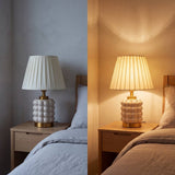 Lámpara de velador PERLA CREAM AND GOLD encendida de noche en dormitorio azul
