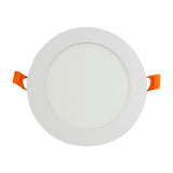 Luminaria spot circular blanca con difusor opalino y resortes de sujeción naranja para empotrar.