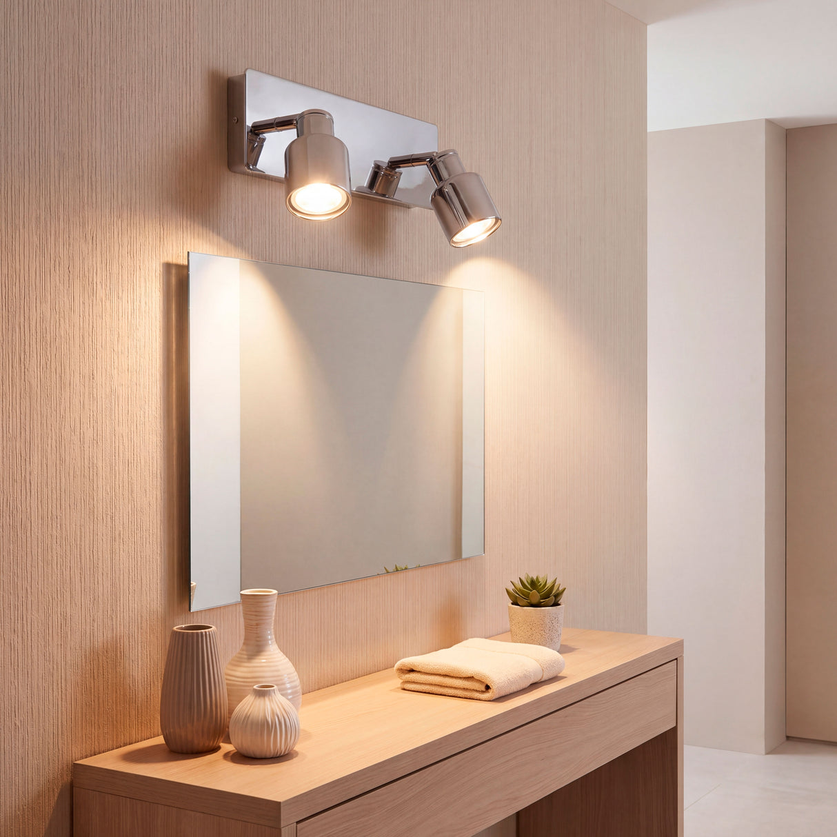 Iluminación de acento directa en zona de lavabo para destacar texturas y elementos.
