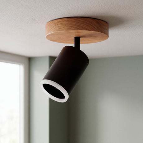 Spot adosable con base de madera y cabezal negro dirigible en el techo