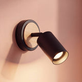 Spot adosable negro con disco de madera como aplique dirigible en la pared