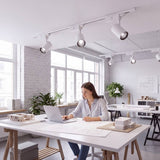 Mujer trabajando en un estudio iluminado con spots LED de riel ROXY White