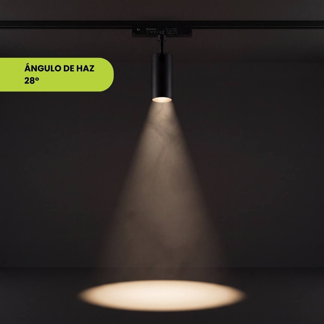 Spot de riel proyectando su cono de luz definido sobre fondo oscuro