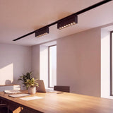 Spot LED magnético articulable en riel de techo sobre comedor moderno