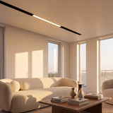 Spot LED lineal en riel de techo iluminando sala de estilo minimalista