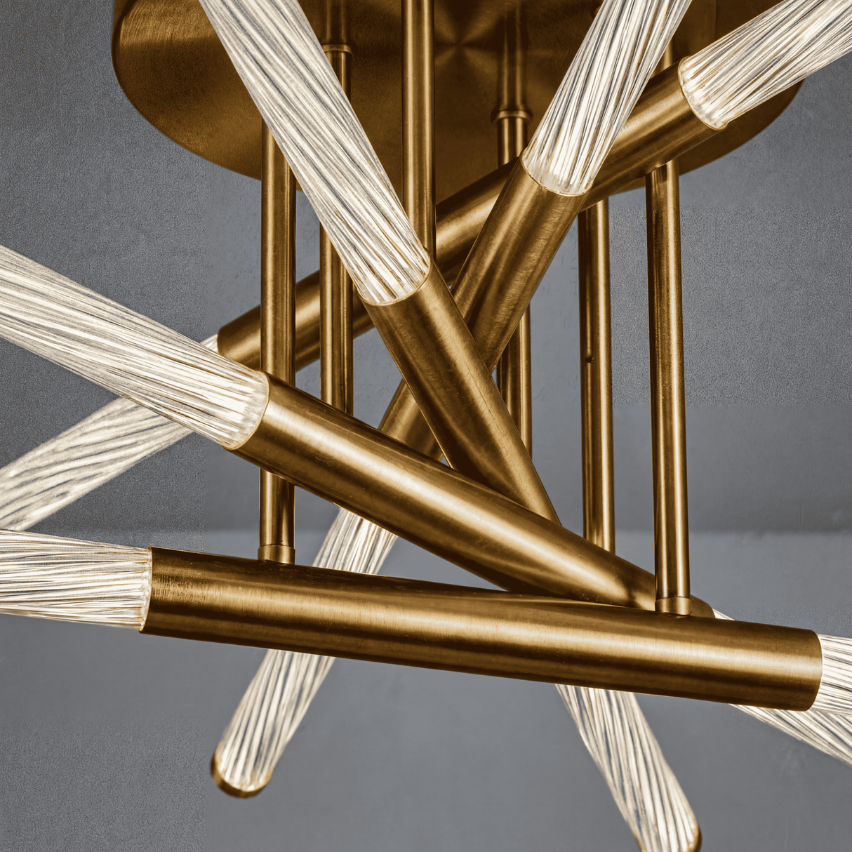 Primer plano de la estructura de aluminio dorado mate y difusores acrílicos estriados.